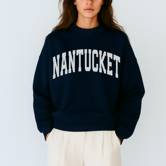Person wearing a navy sweatshirt with 'NANTUCKET' text on a light gray background