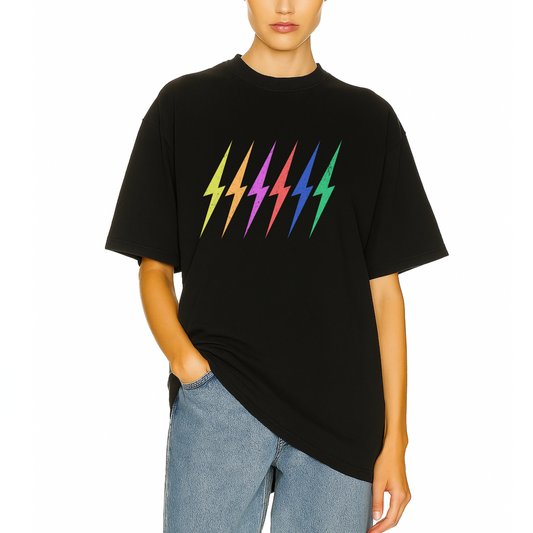 Model wearing Côte Crew’s black t-shirt featuring multicolor lightning bolts for a bold, colorful statement look