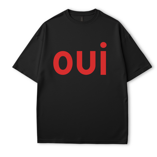  Flat lay of Côte Crew’s black graphic t-shirt featuring bold red “oui” text in minimalist style